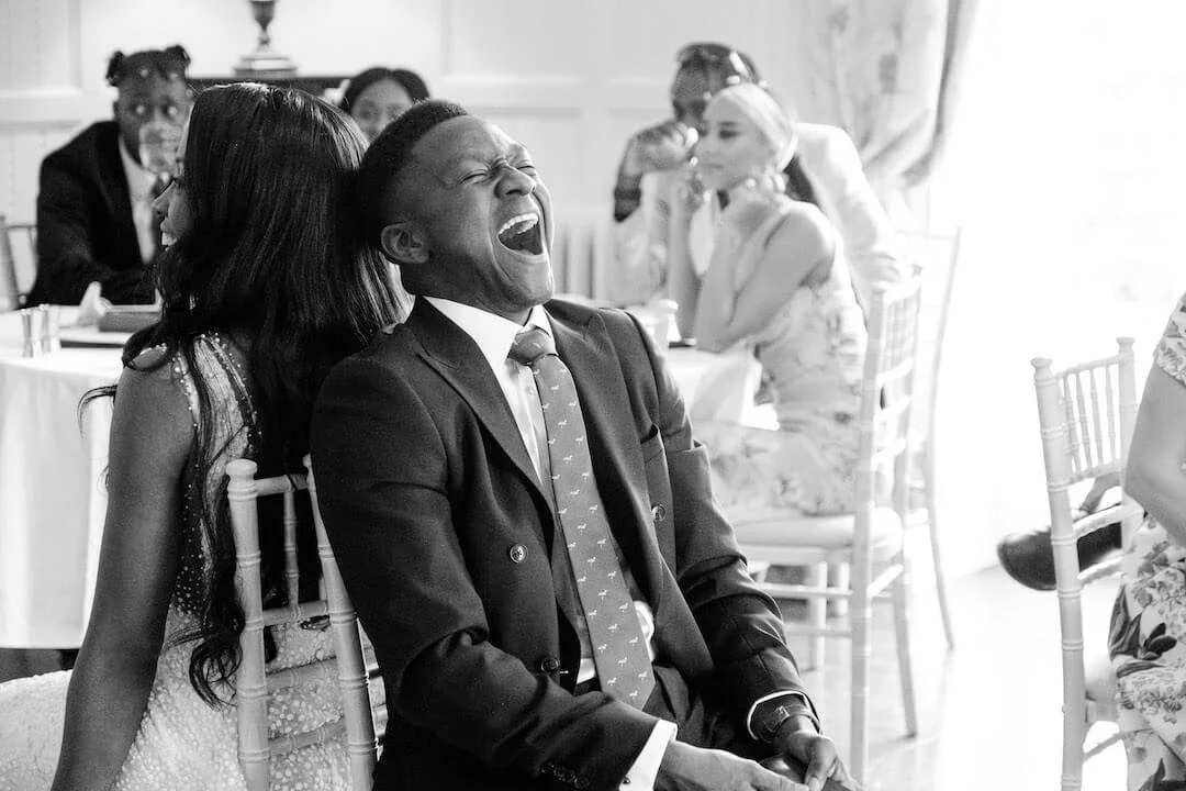 Quizmaster reading Mr and Mrs questions to the laughing couple