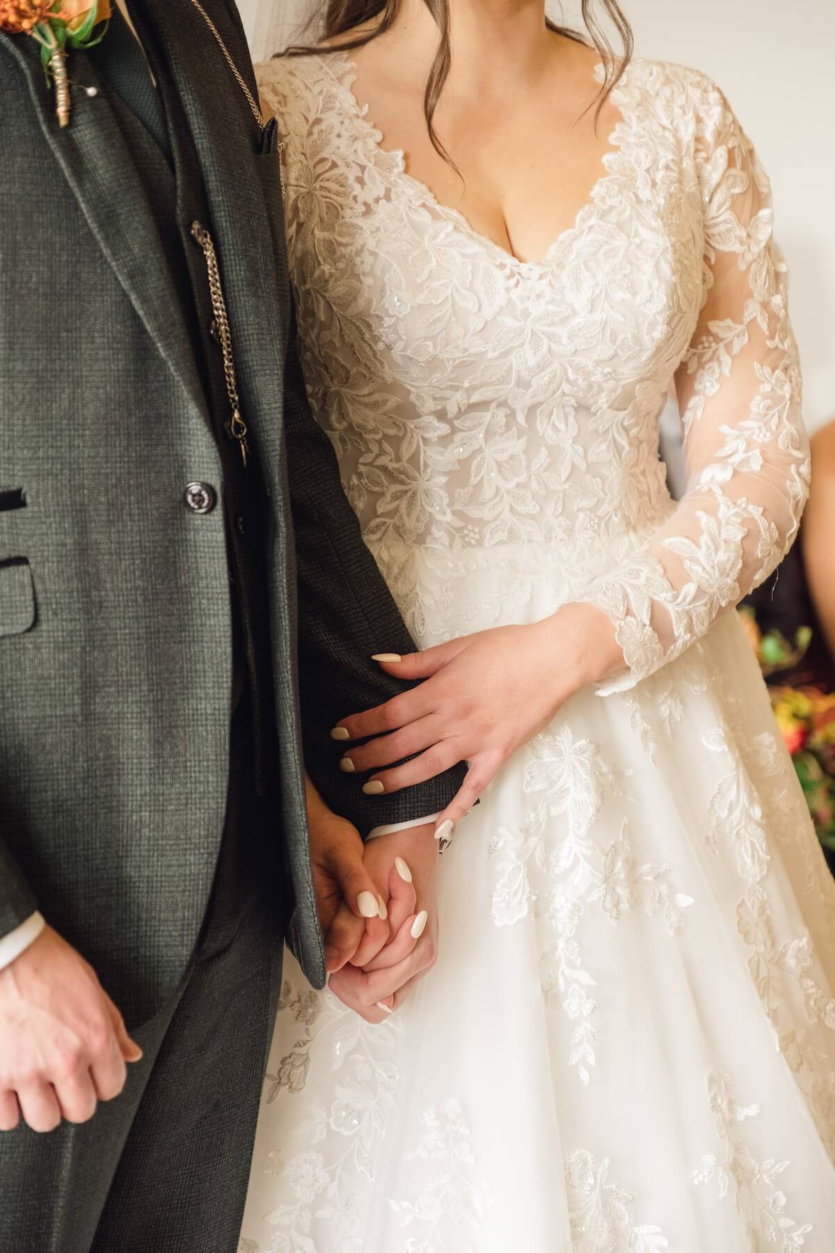 Bride and groom holding hands at Standon Hall