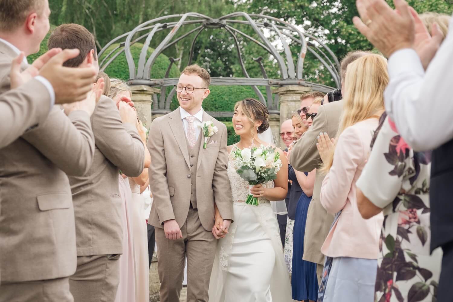 Just married couple walking back down the aisle at Birtsmorton Court