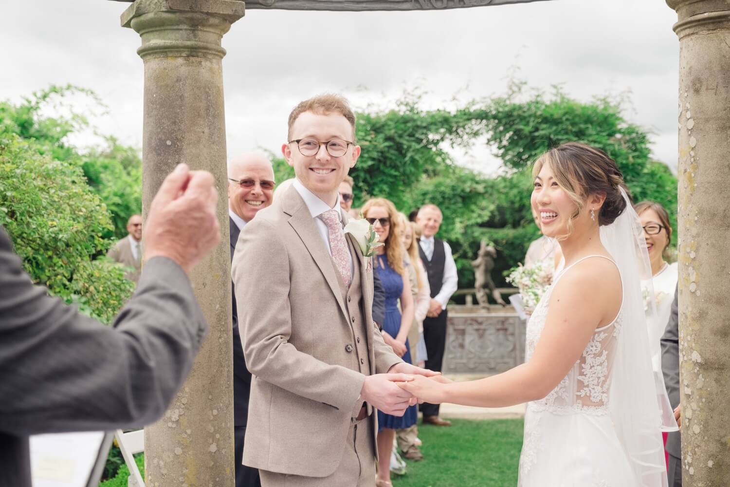 Bride and groom holding hands at their Birtsmorton Court wedding