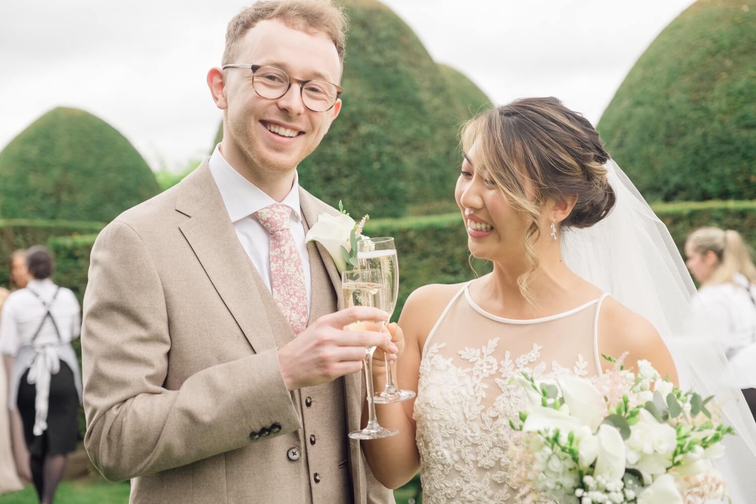 Bride and groom toasting with champagne at Birtsmorton Court