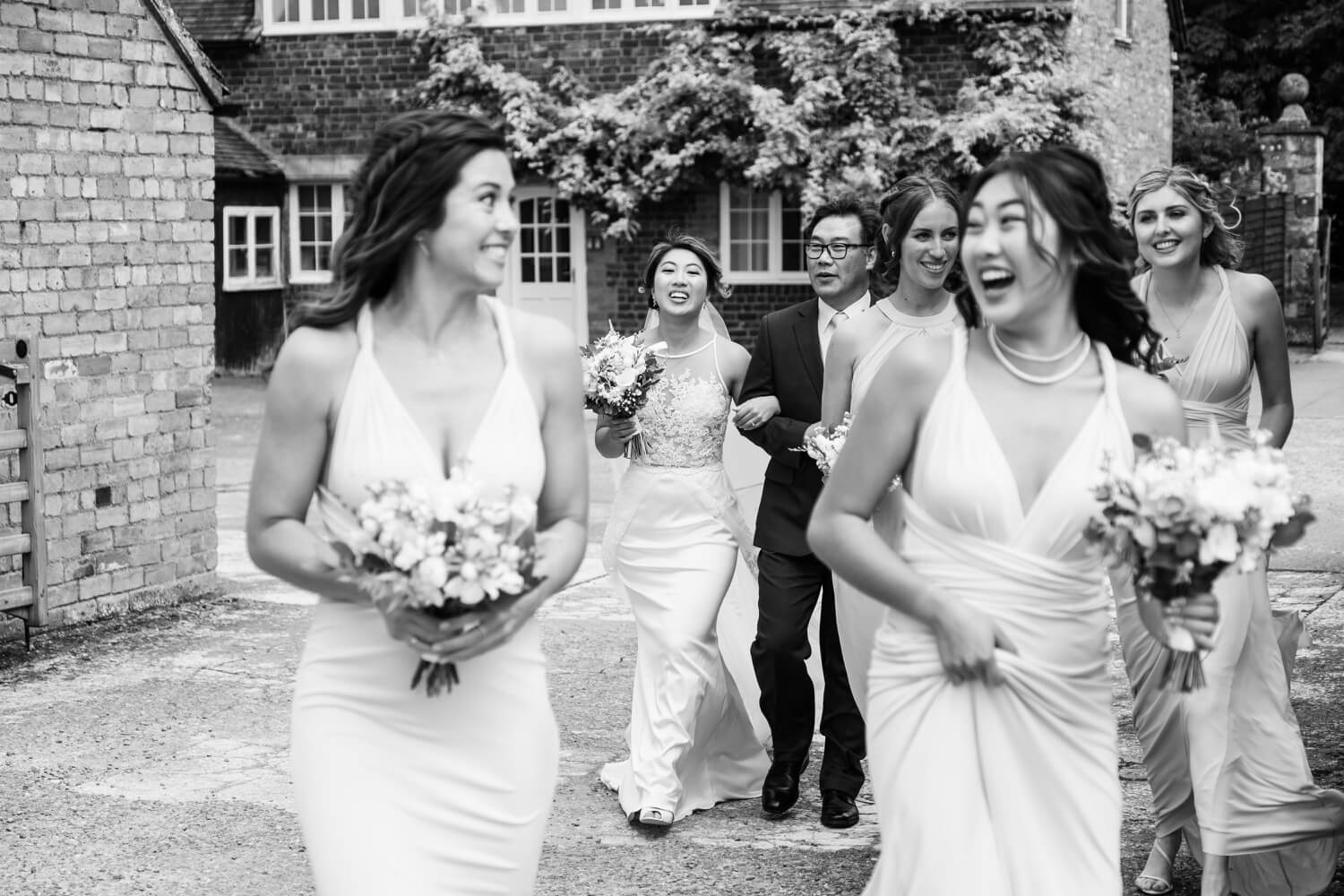 Bridal party walking through the grounds at Birtsmorton Court
