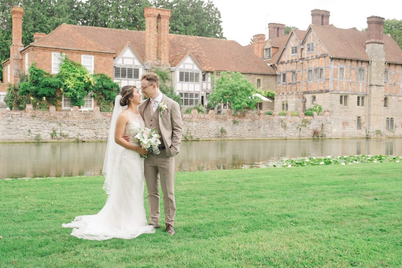 Bride and groom in front of the house at Birtsmorton Court