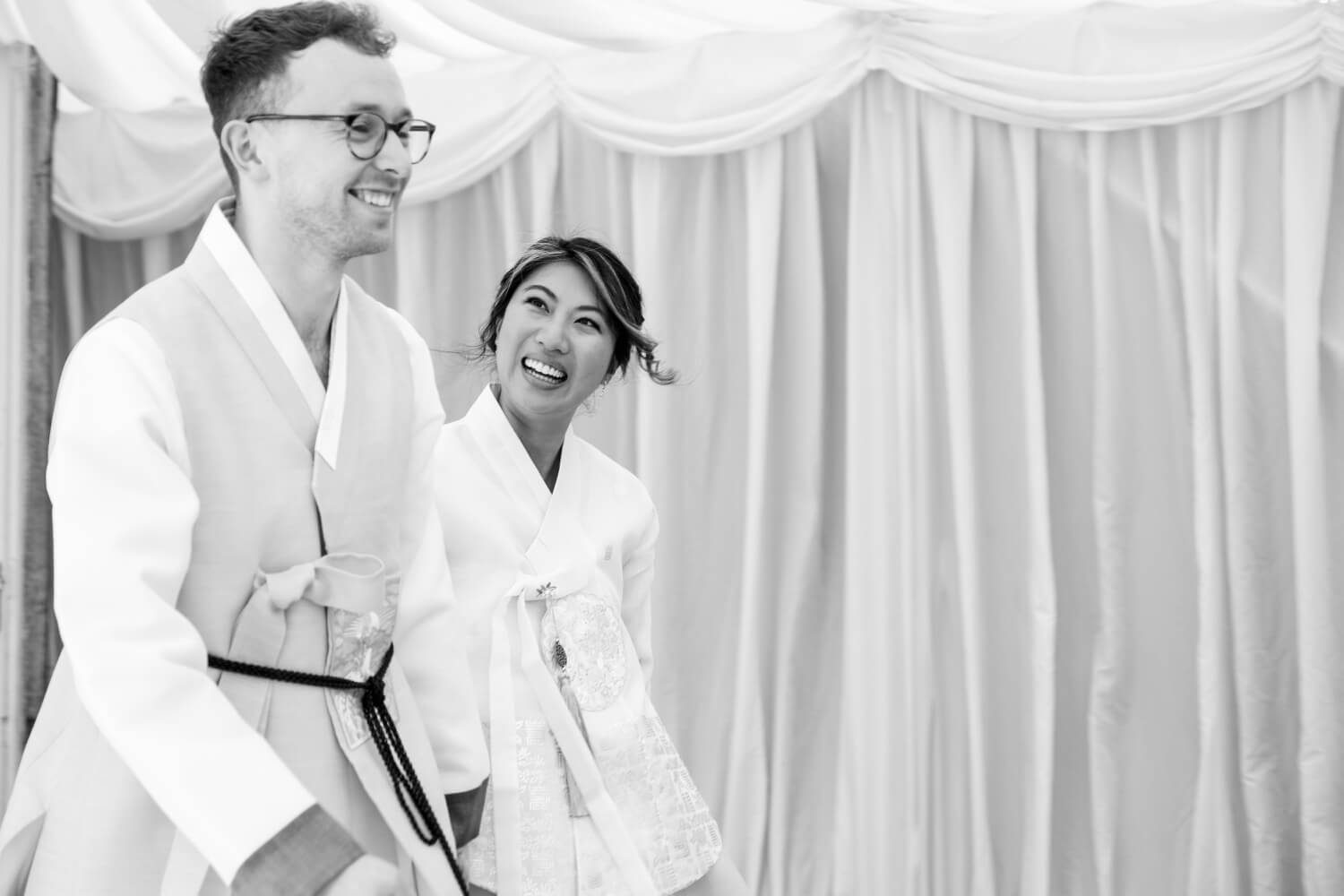 Bride and groom walking into the wedding breakfast at Birtsmorton Court
