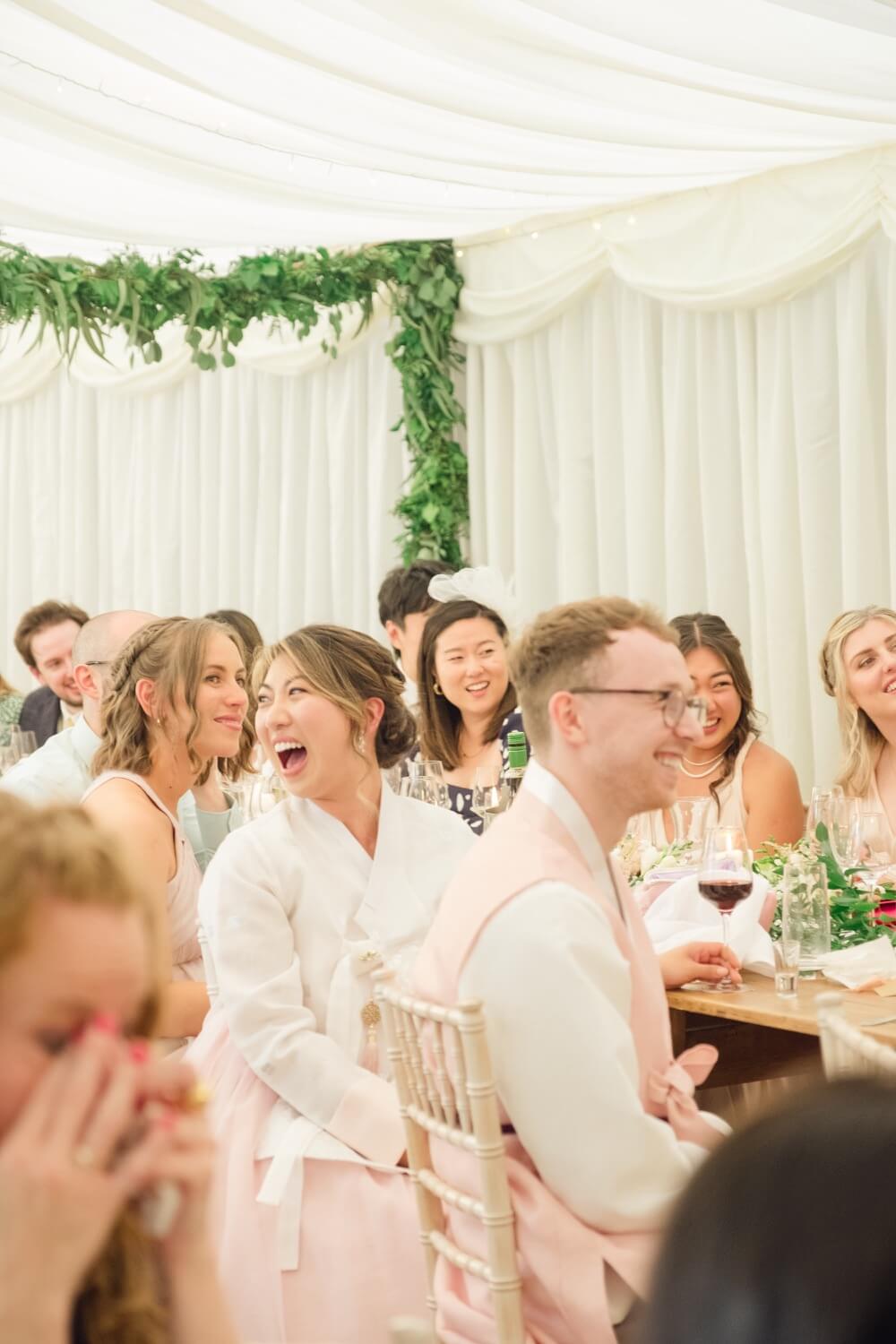 Bride laughing during the speeches at Birtsmorton Court