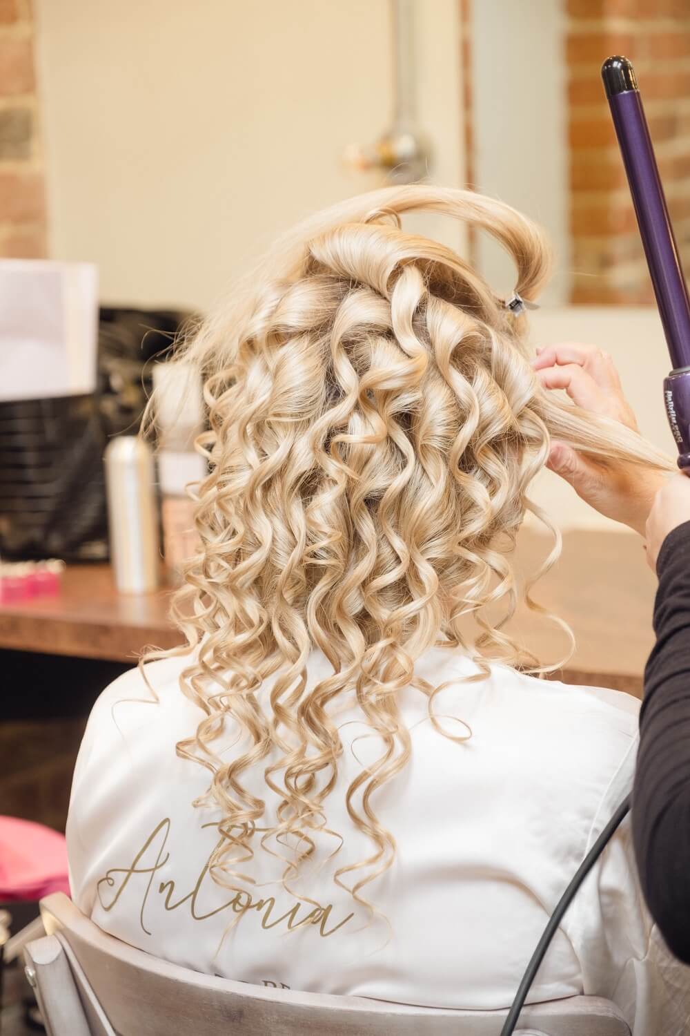 Bride having her hair styled in the Foxtail Barns dressing room