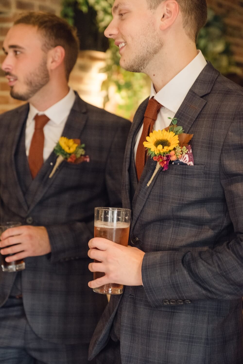 Groom and best man sharing a pint before the ceremony at Foxtail Barns