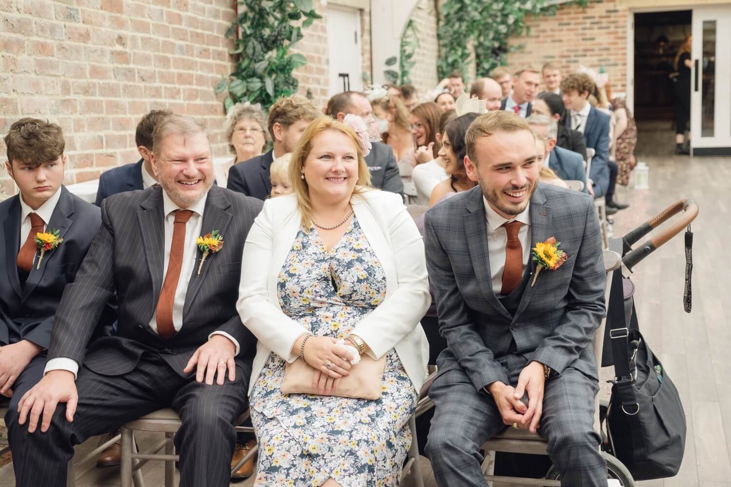Guests laughing during the ceremony at Foxtail Barns