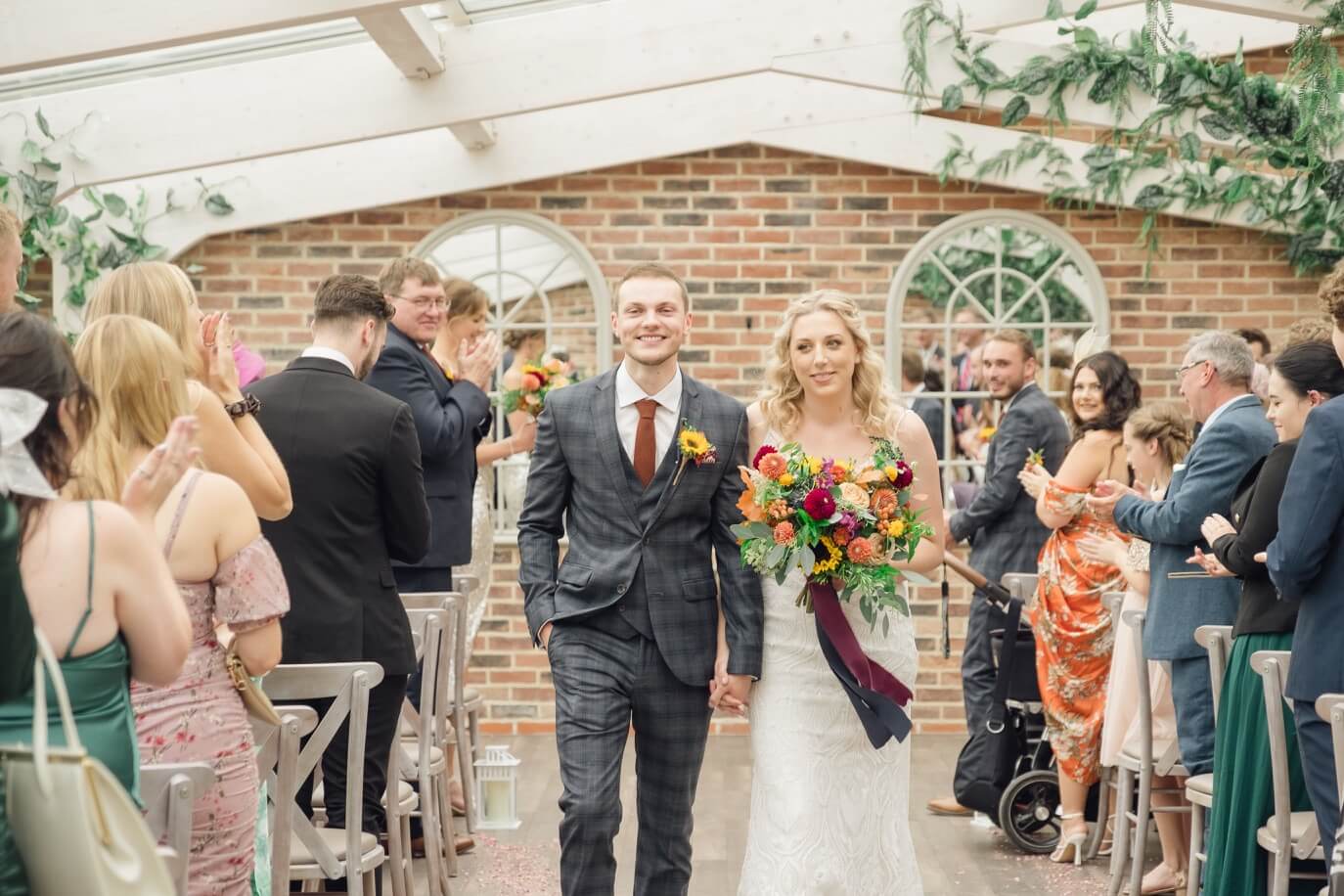 Bride and groom walking back up the aisle at their Foxtail Barns wedding