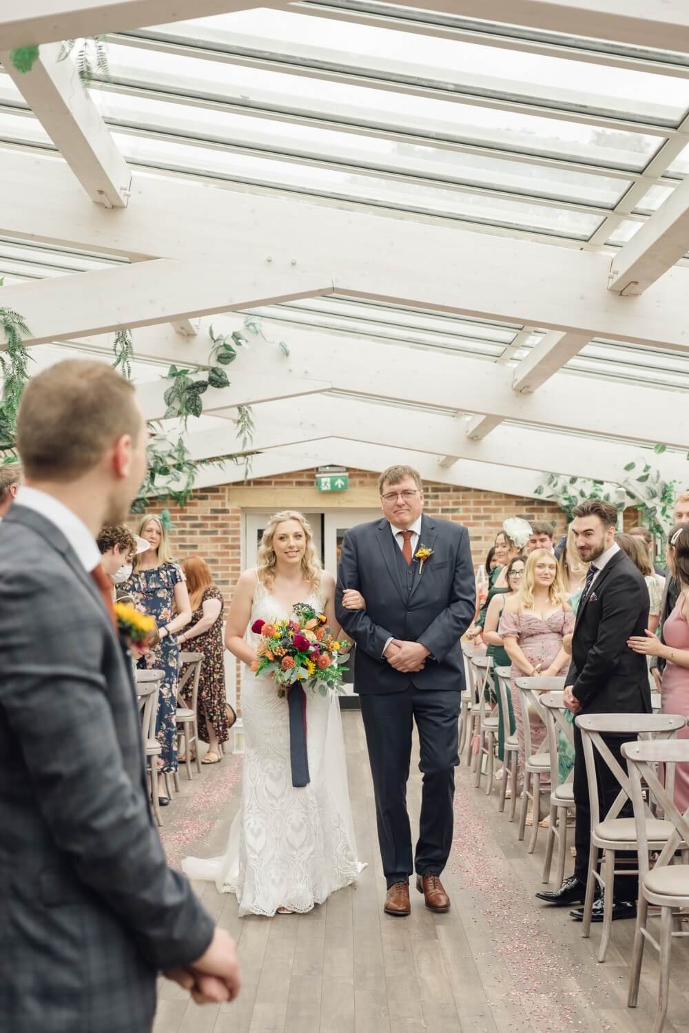 Bride halfway down the aisle at her Foxtail Barns wedding
