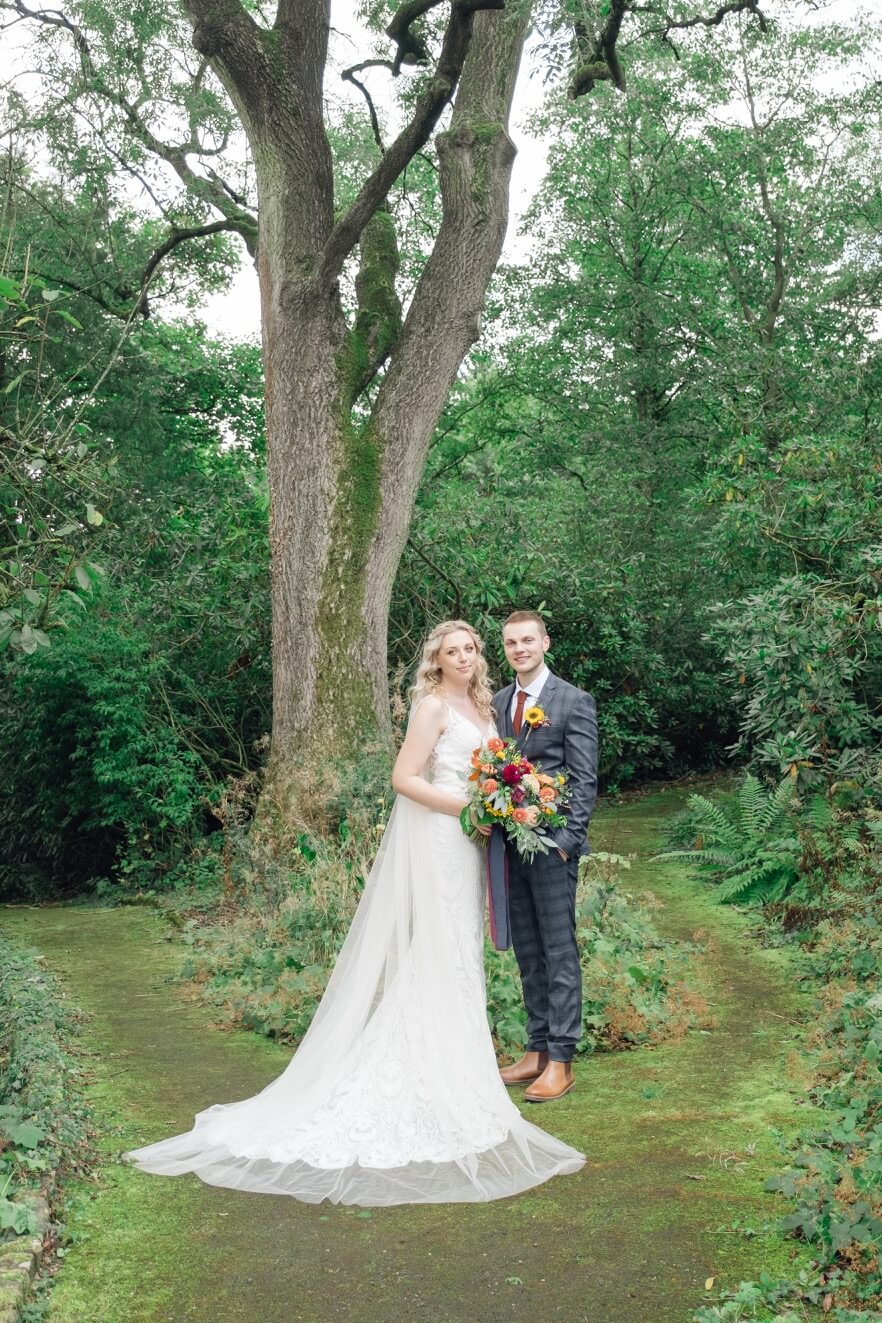Bride and groom together in the walled gardens at Foxtail Barns