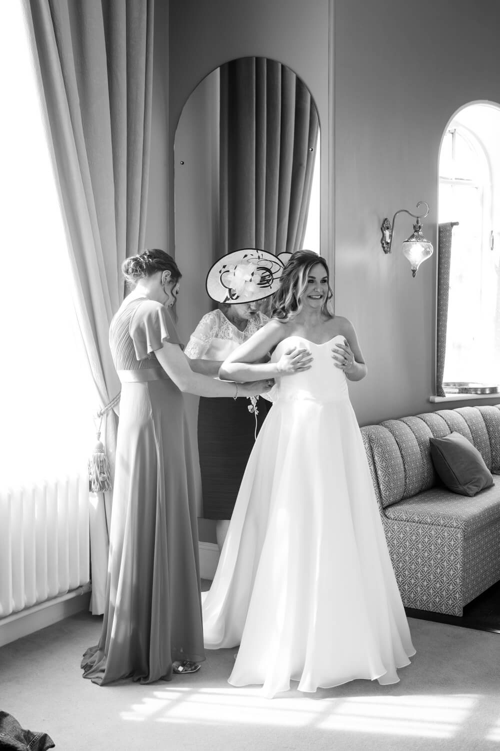 Bride getting into her dress at Hawkstone Hall