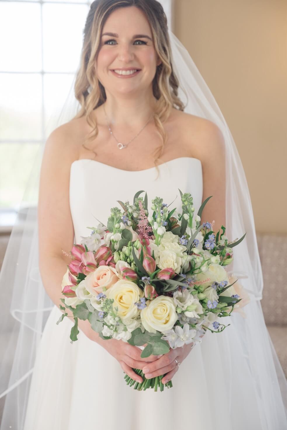 Bride with her flowers at Hawkstone Hall