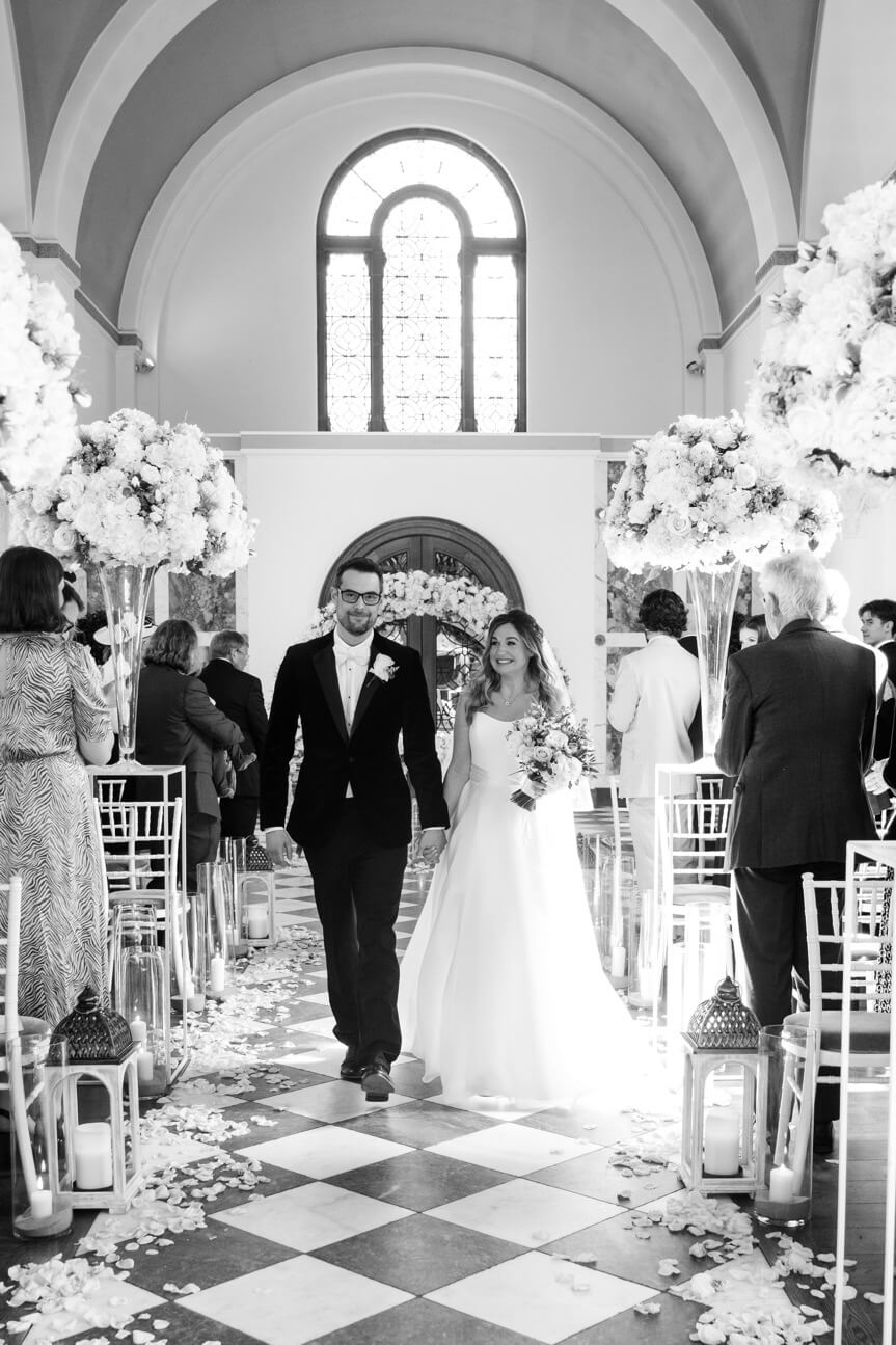 Married couple walking down the aisle at Hawkstone Hall
