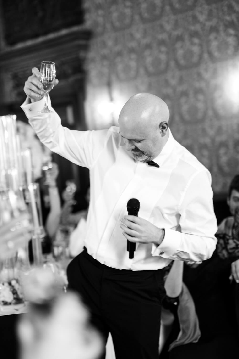Best man raising a champagne glass at Hawkstone Hall