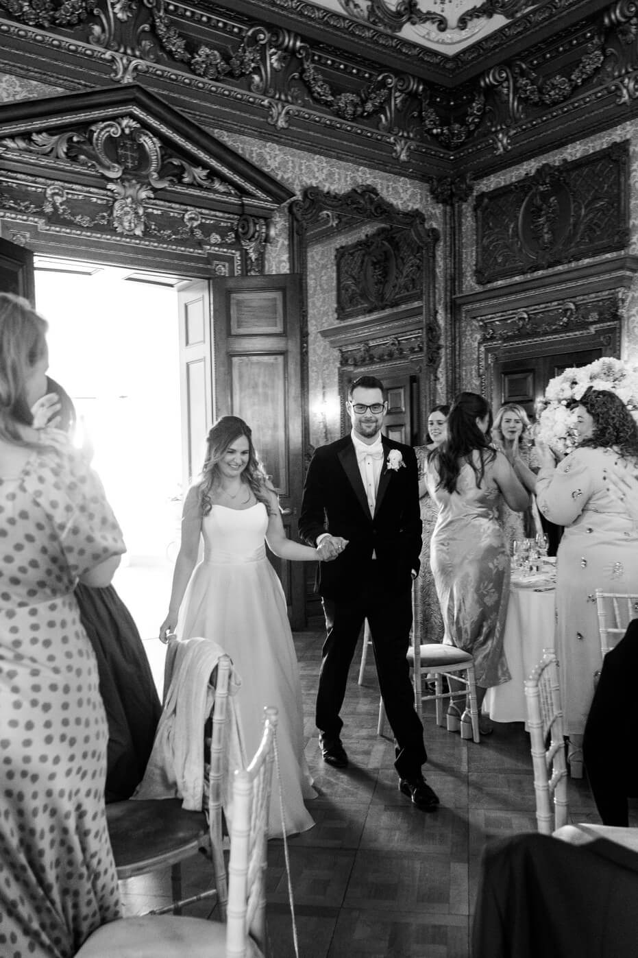 Bride and groom entering the wedding breakfast at Hawkstone Hall