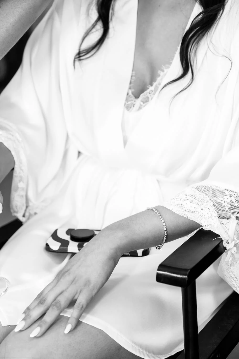 Bride in her gown having final makeup