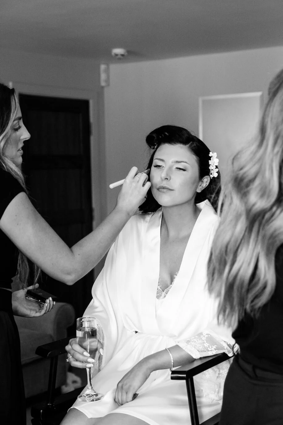 Bride having her makeup done before the wedding
