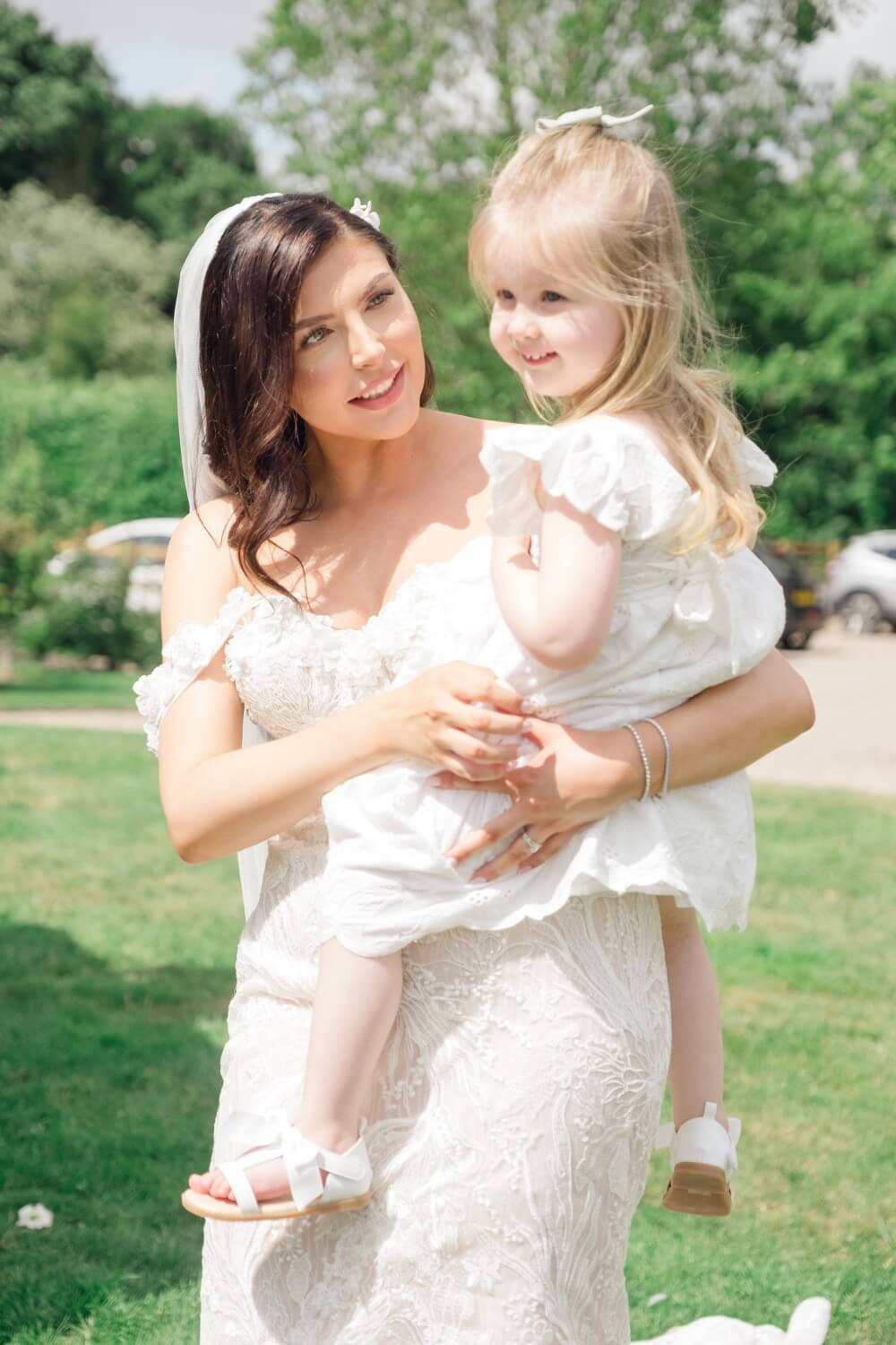 Bride holding a young girl at the reception
