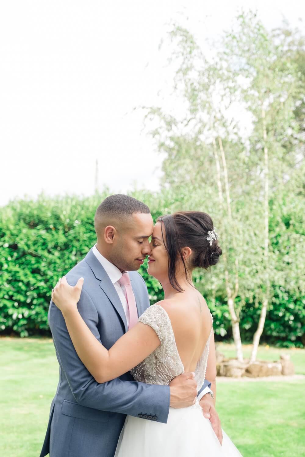 Romantic couple portrait at their red house barn wedding