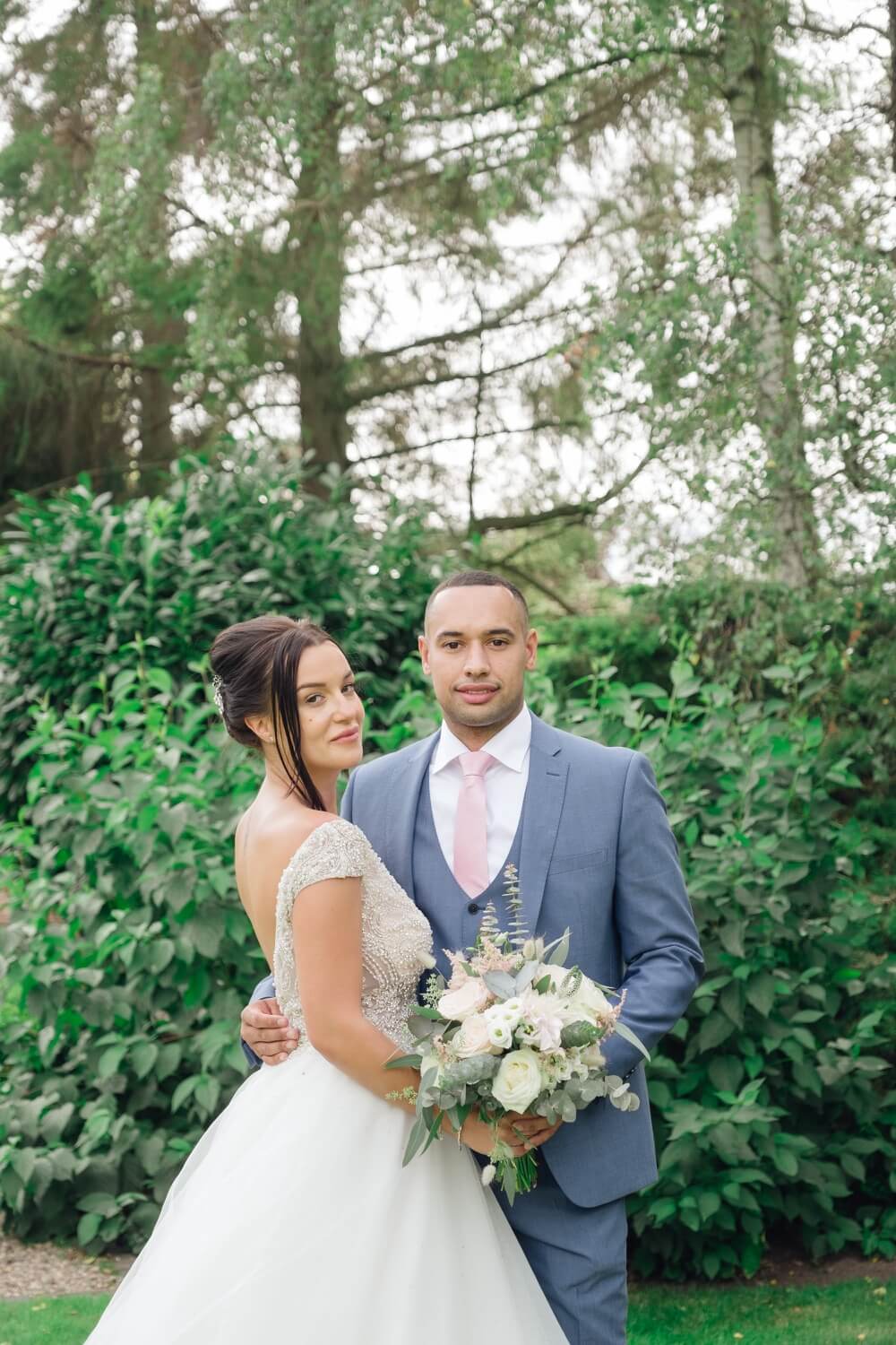 Newlyweds laughing together in the Redhouse Barn gardens