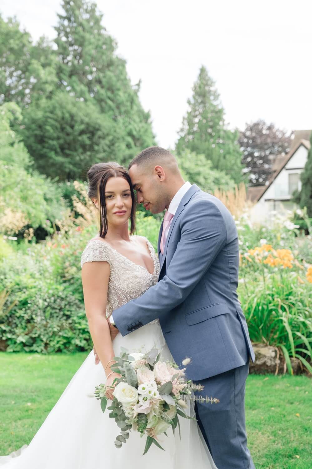 Bride and groom together during their garden portrait session at Redhouse Barn