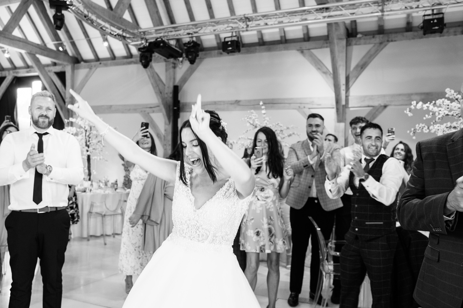 Bride dancing her way into the wedding breakfast at Redhouse Barn