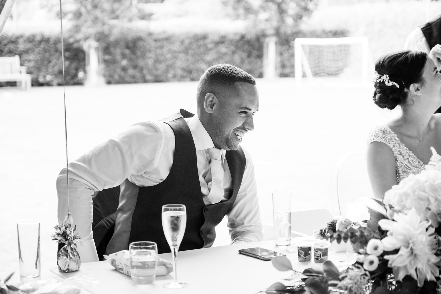 Groom laughing during the wedding speeches