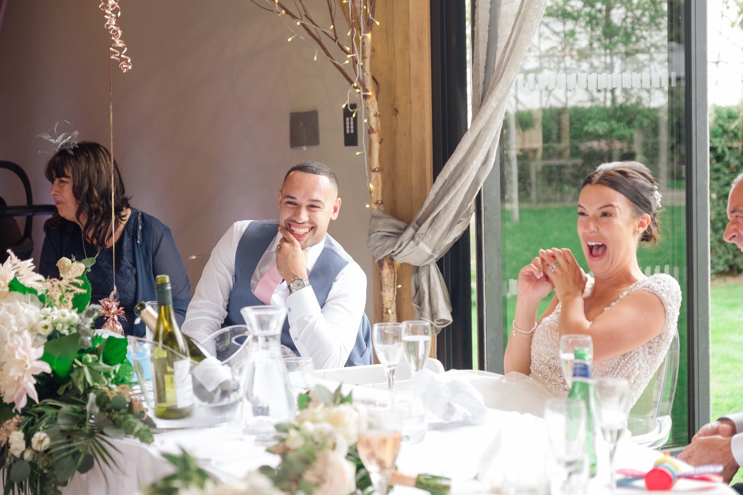 Bride reacting in shock to the best man's speech at Redhouse Barn
