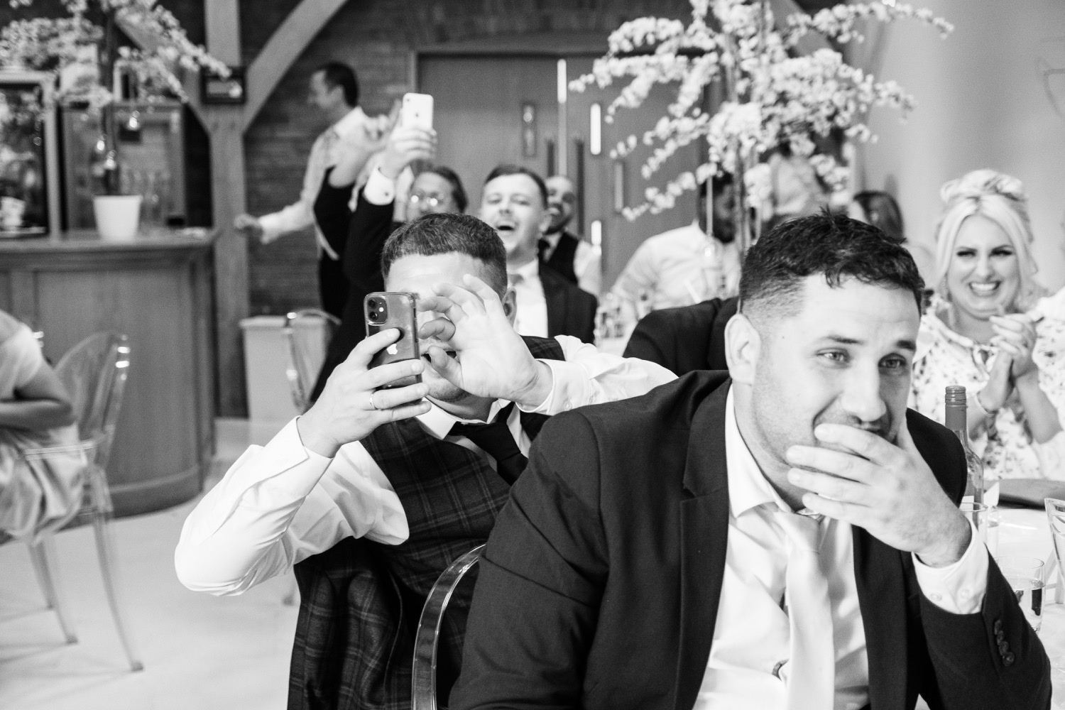 Wedding guests taking photos of the entrance at Redhouse Barn