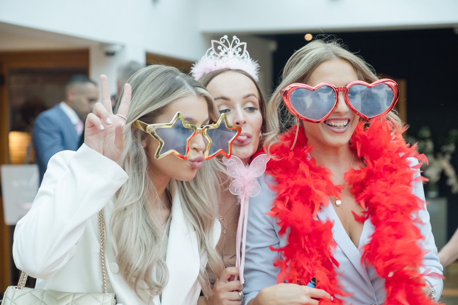 Guests in photo booth props at the Redhouse Barn evening reception