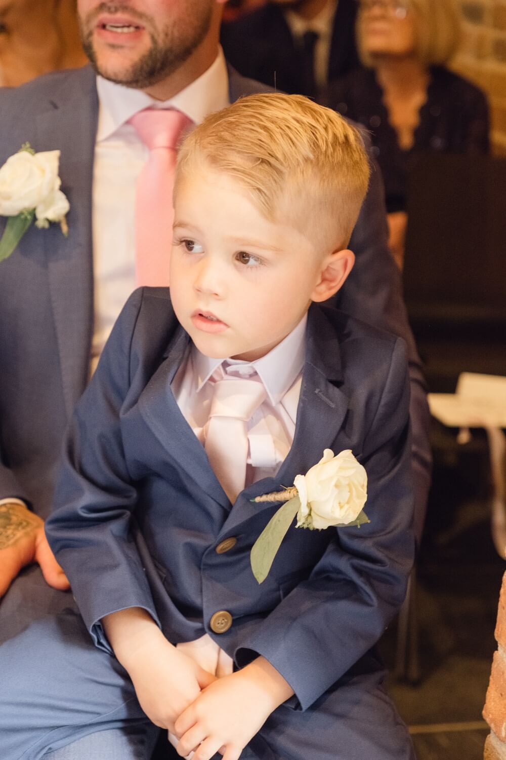 Young boy watching the wedding ceremony at Redhouse Barn