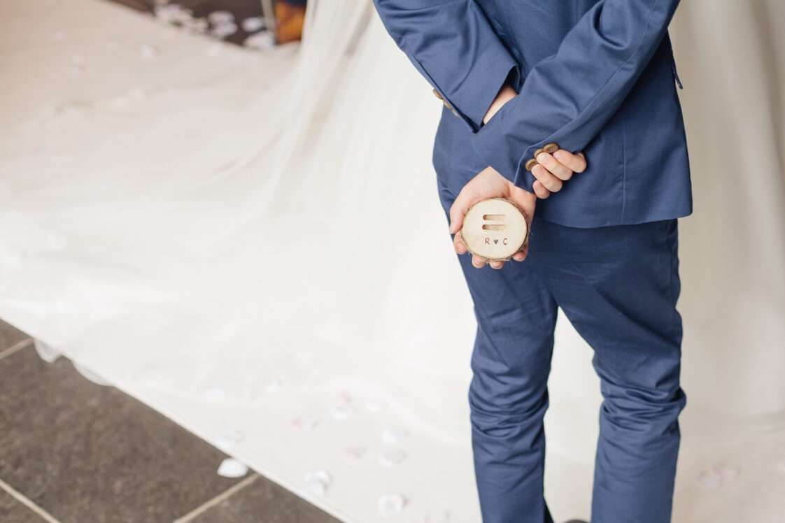 Page boy holding the wedding rings during the ceremony