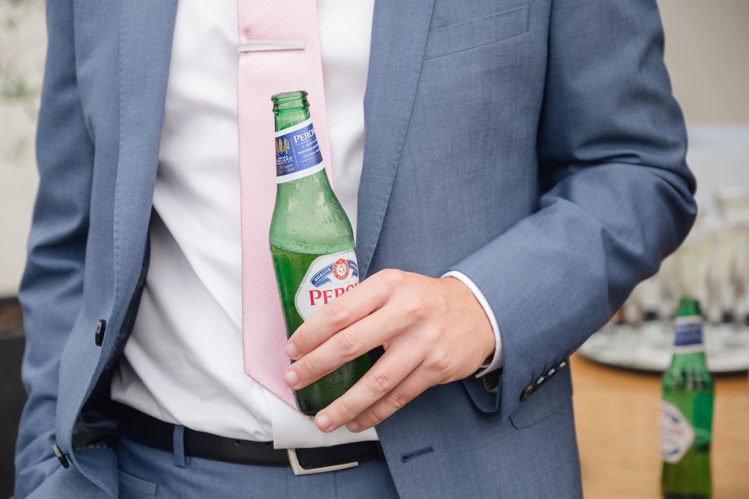 Wedding guest enjoying a beer at the Redhouse Barn drinks reception