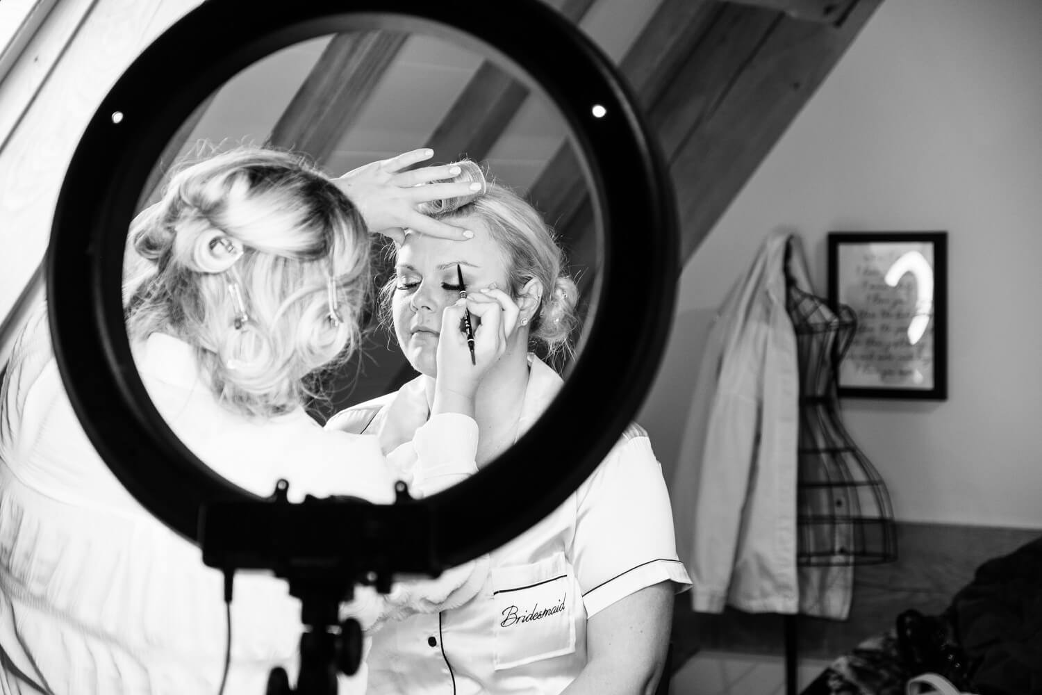 Young girl having her makeup done on the wedding morning