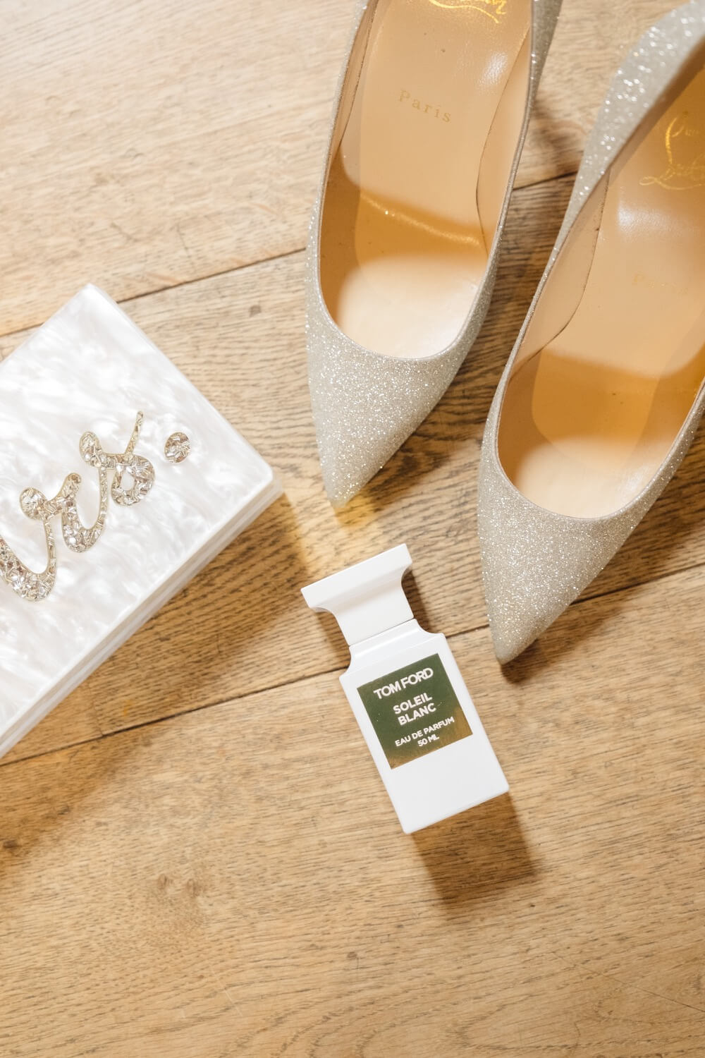 Detail of the bride's shoes and perfume before the ceremony