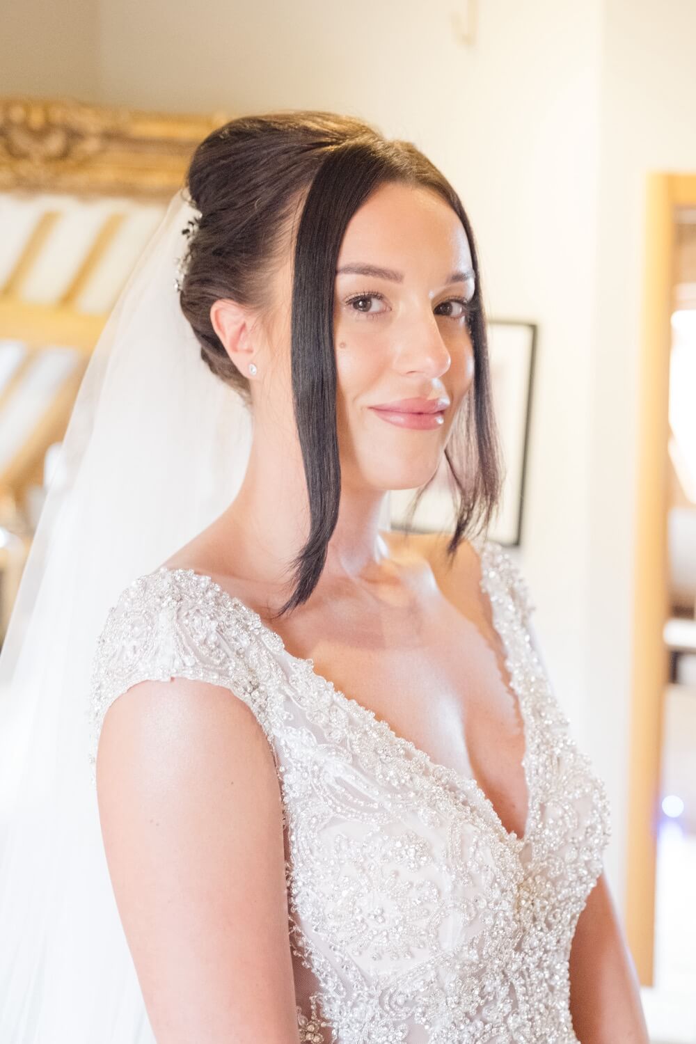 Bride ready in her dress with hair and makeup finished