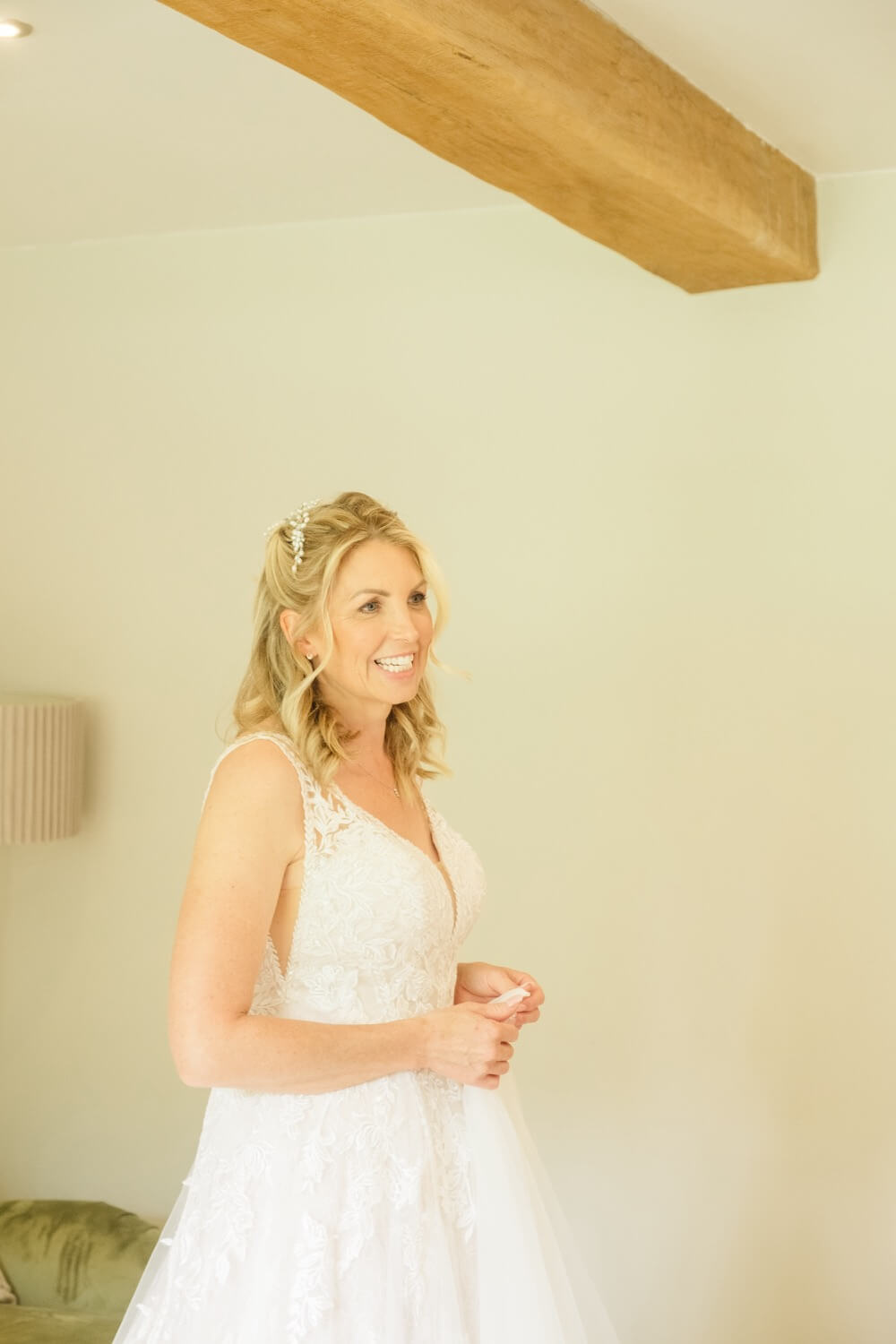Smiling bride ready to leave for her wedding at Shustoke Barn in Warwickshire
