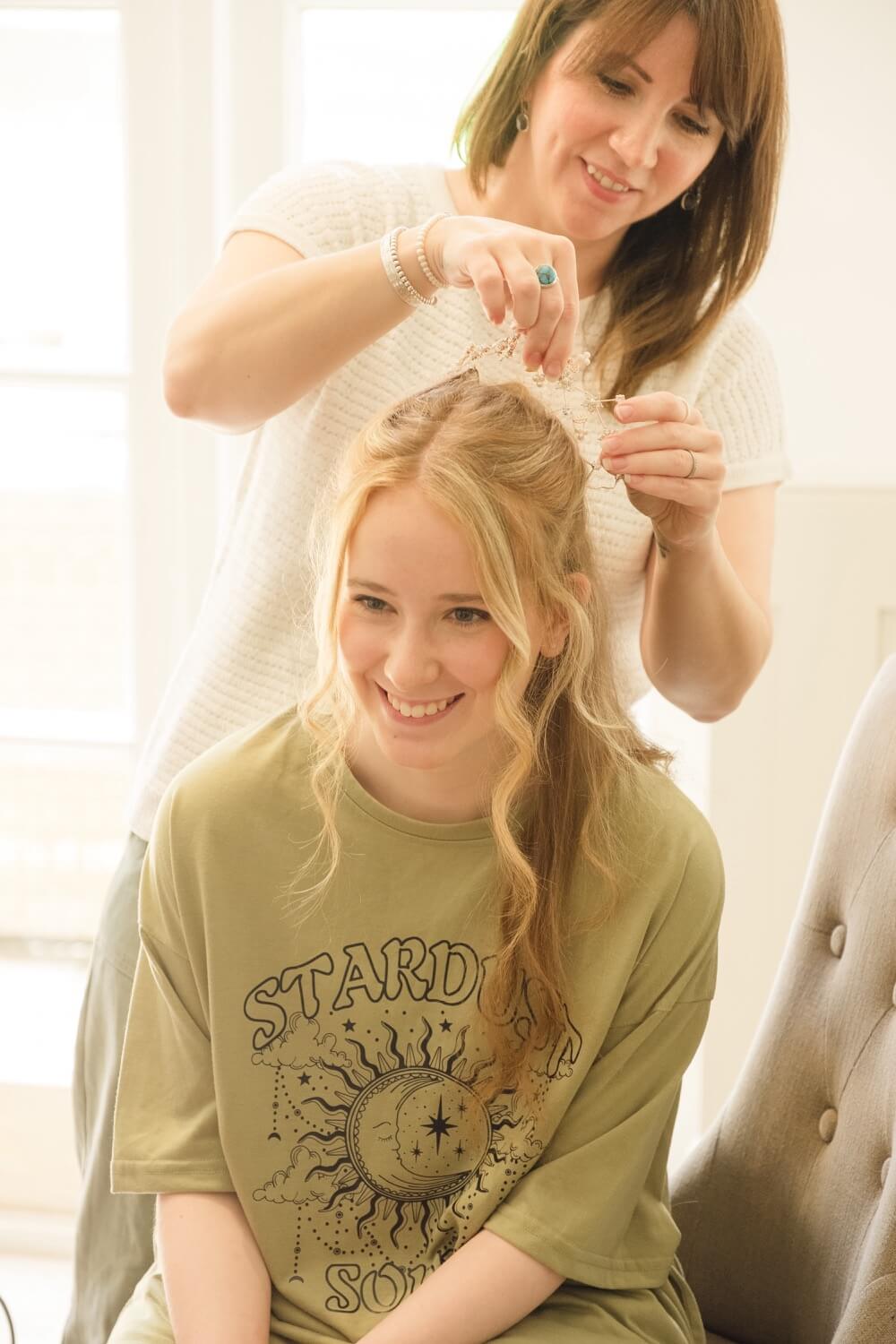 Bridesmaid having her hair styled on the wedding morning