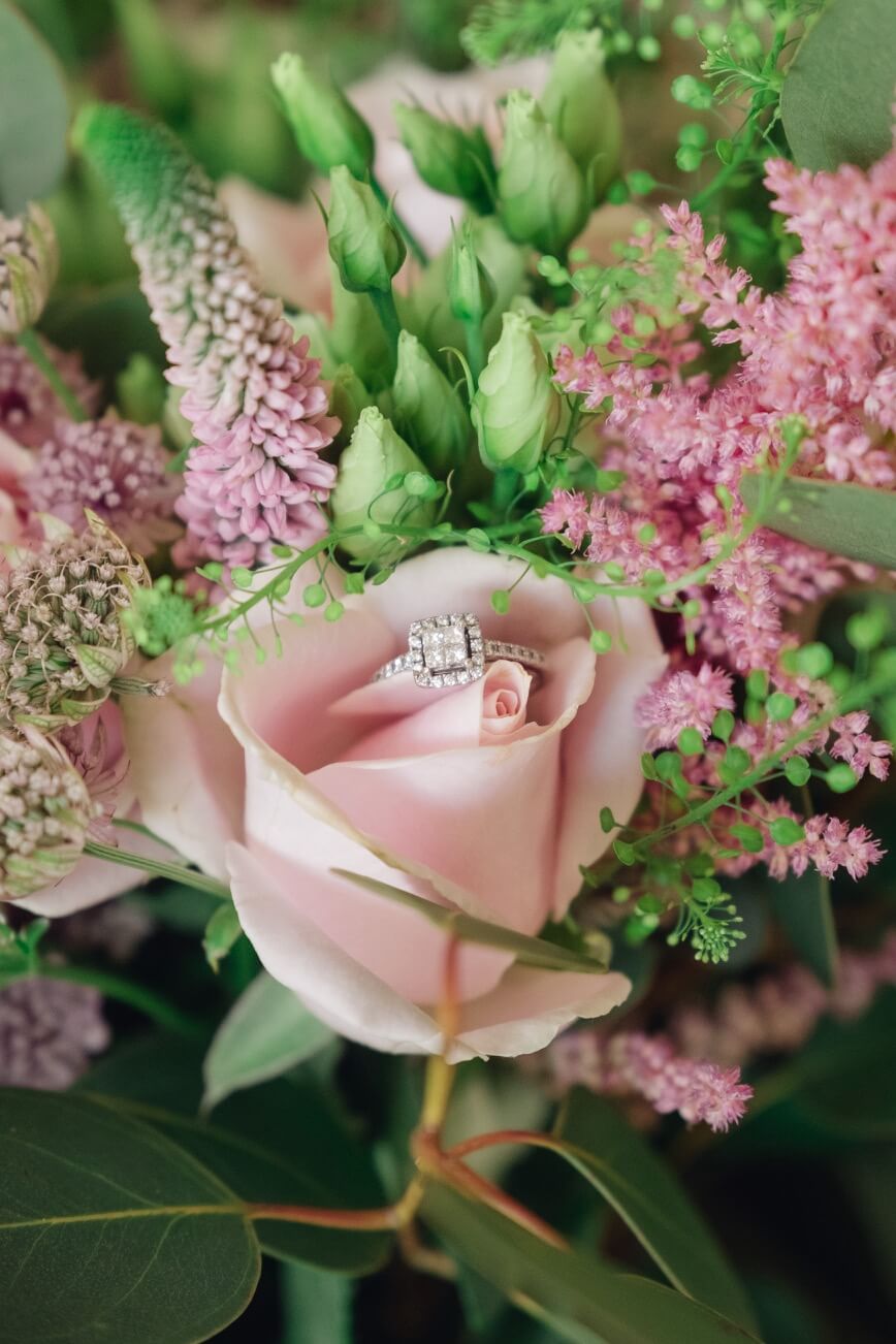 Wedding ring nestled in the bridal flowers
