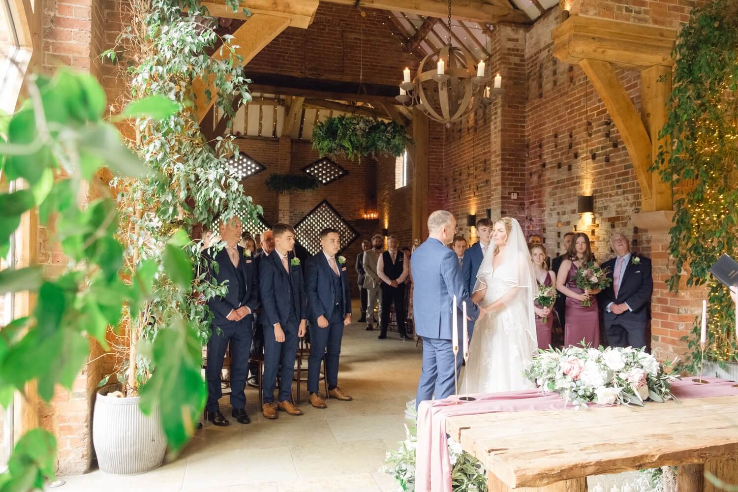Wide view of the wedding ceremony inside Shustoke Farm Barns