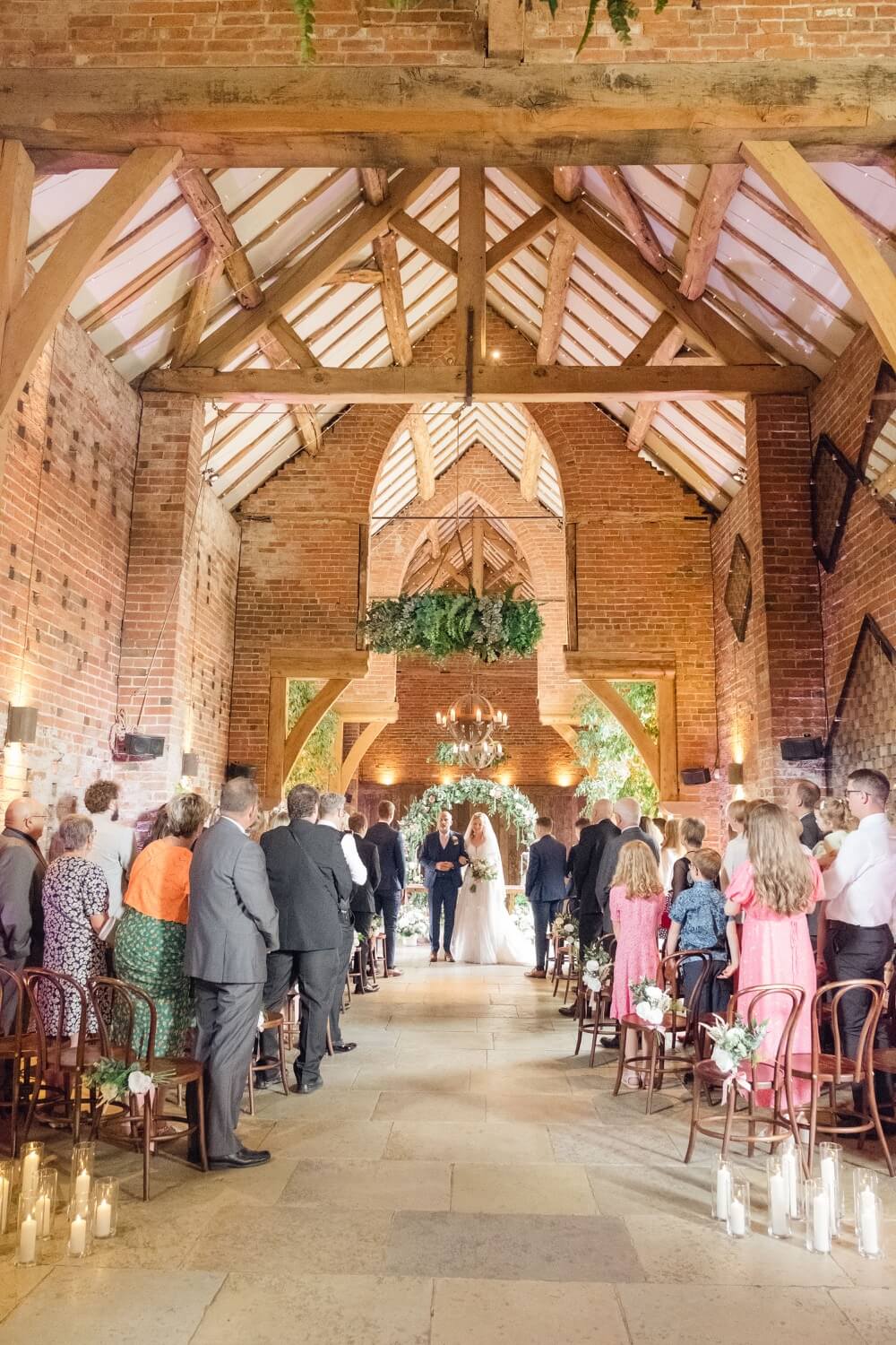 Just married couple leaving their Shustoke Barn wedding ceremony