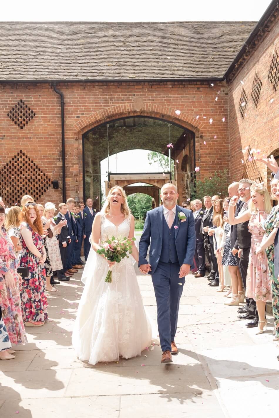 Confetti thrown over the newlyweds in the courtyard at Shustoke Barn