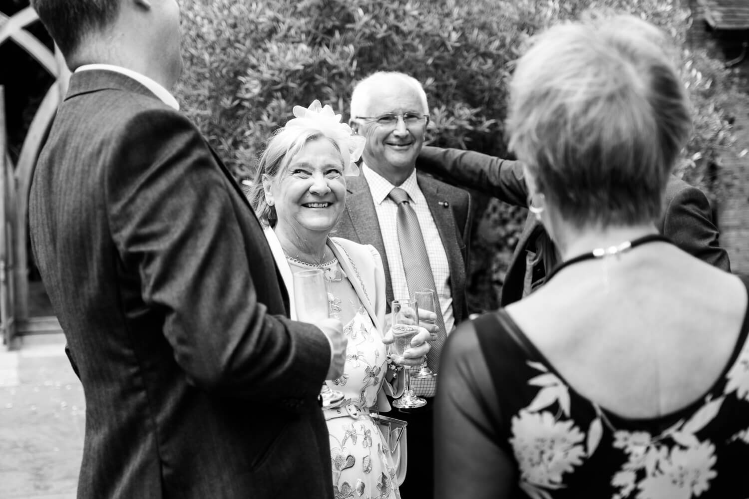 Guests enjoying the drinks reception at a Shustoke Barn wedding