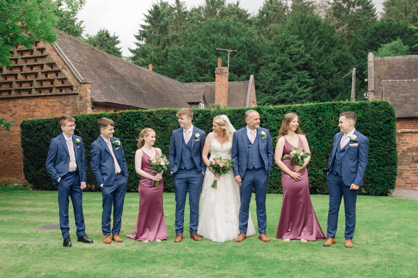 Wedding group photo in front of Shustoke Farm Barns