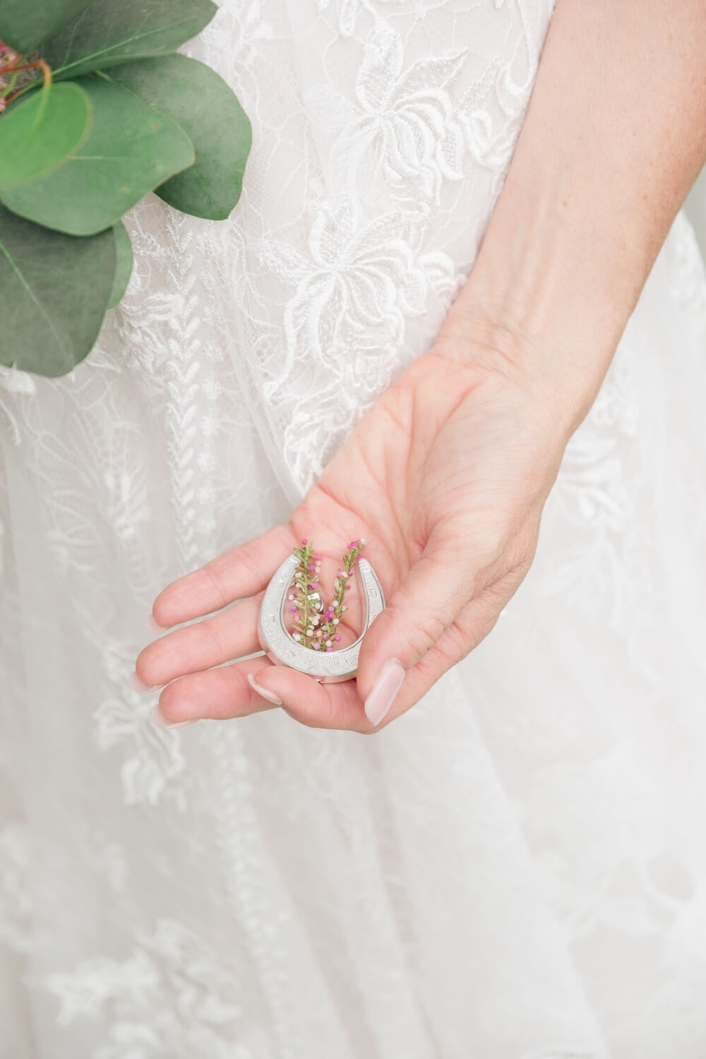 Bride holding her lucky charm at her Shustoke Barn wedding