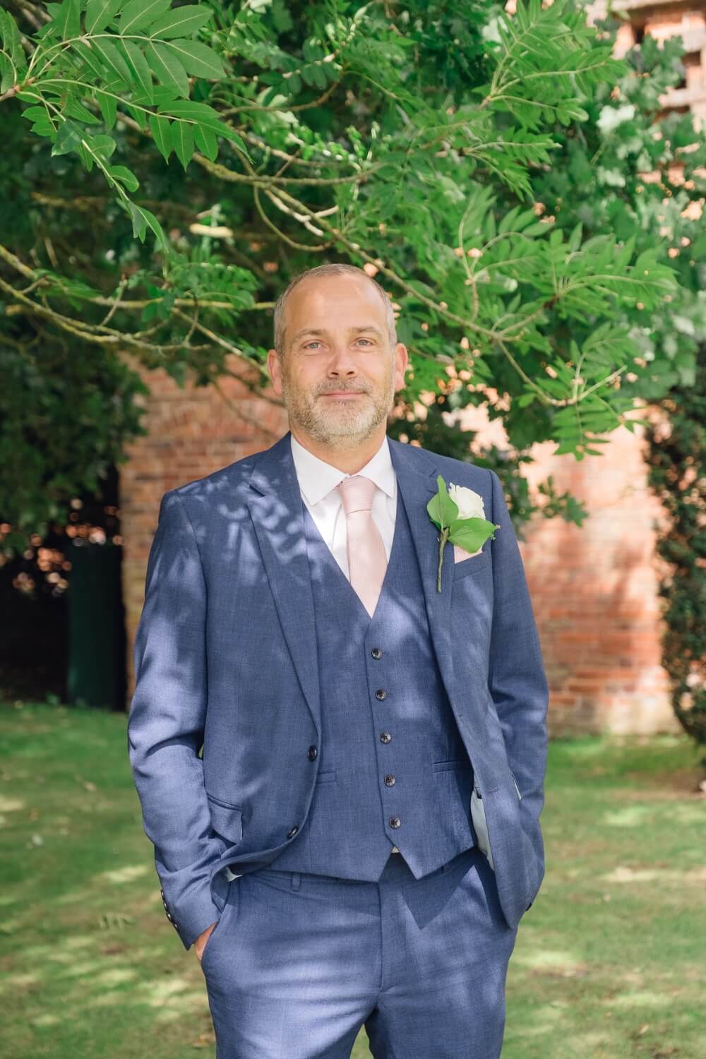 Groom photographed during the drinks reception at Shustoke Barn