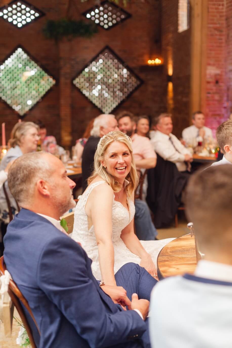 Bride smiling at her groom during the wedding speeches