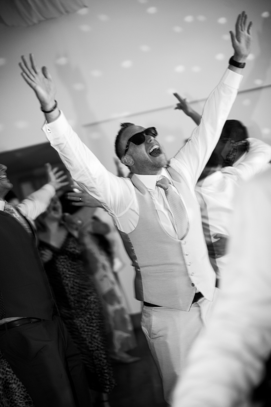Guests celebrating on the dancefloor at Mythe Barn