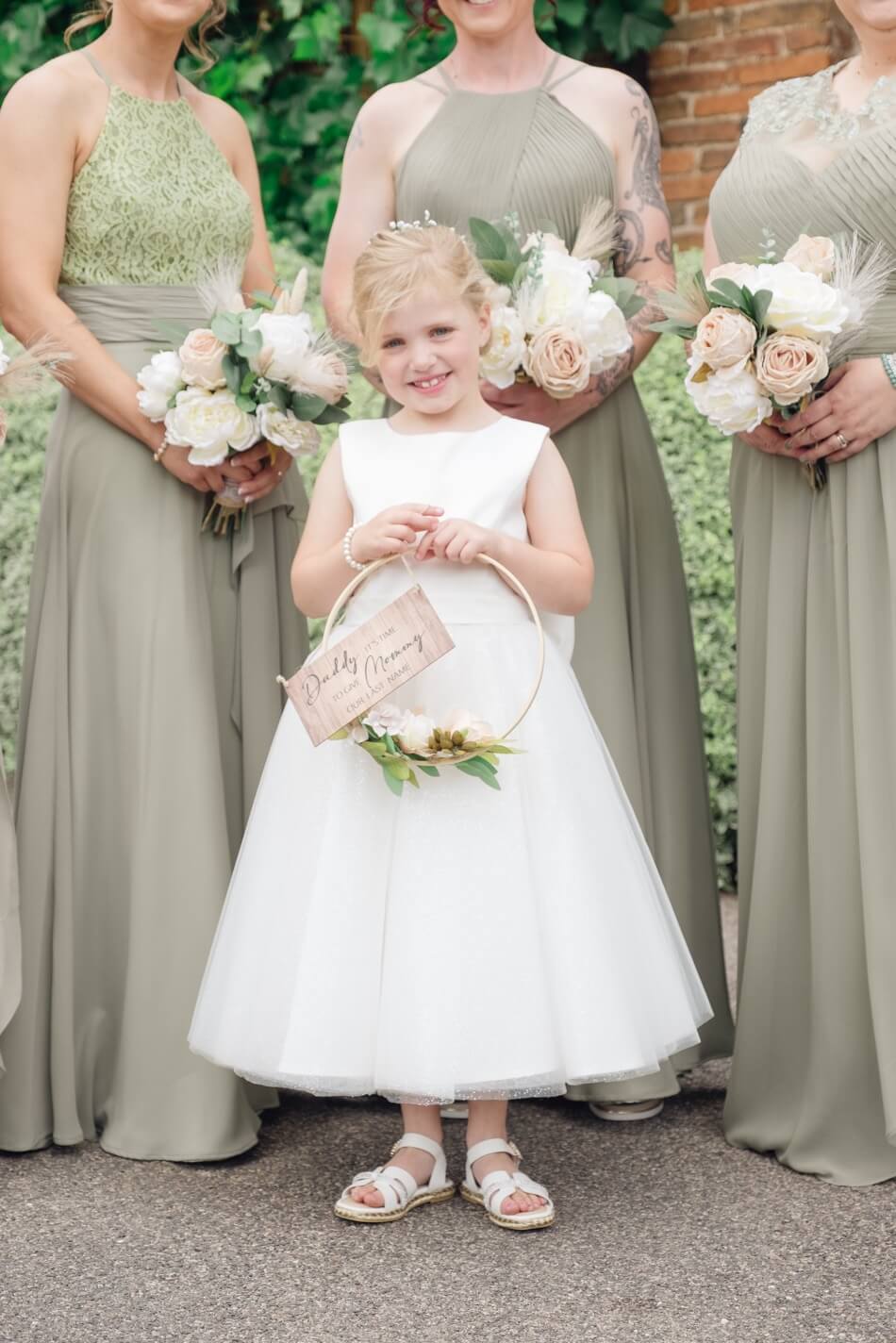 The flower girl in front of the bridesmaids before the ceremony